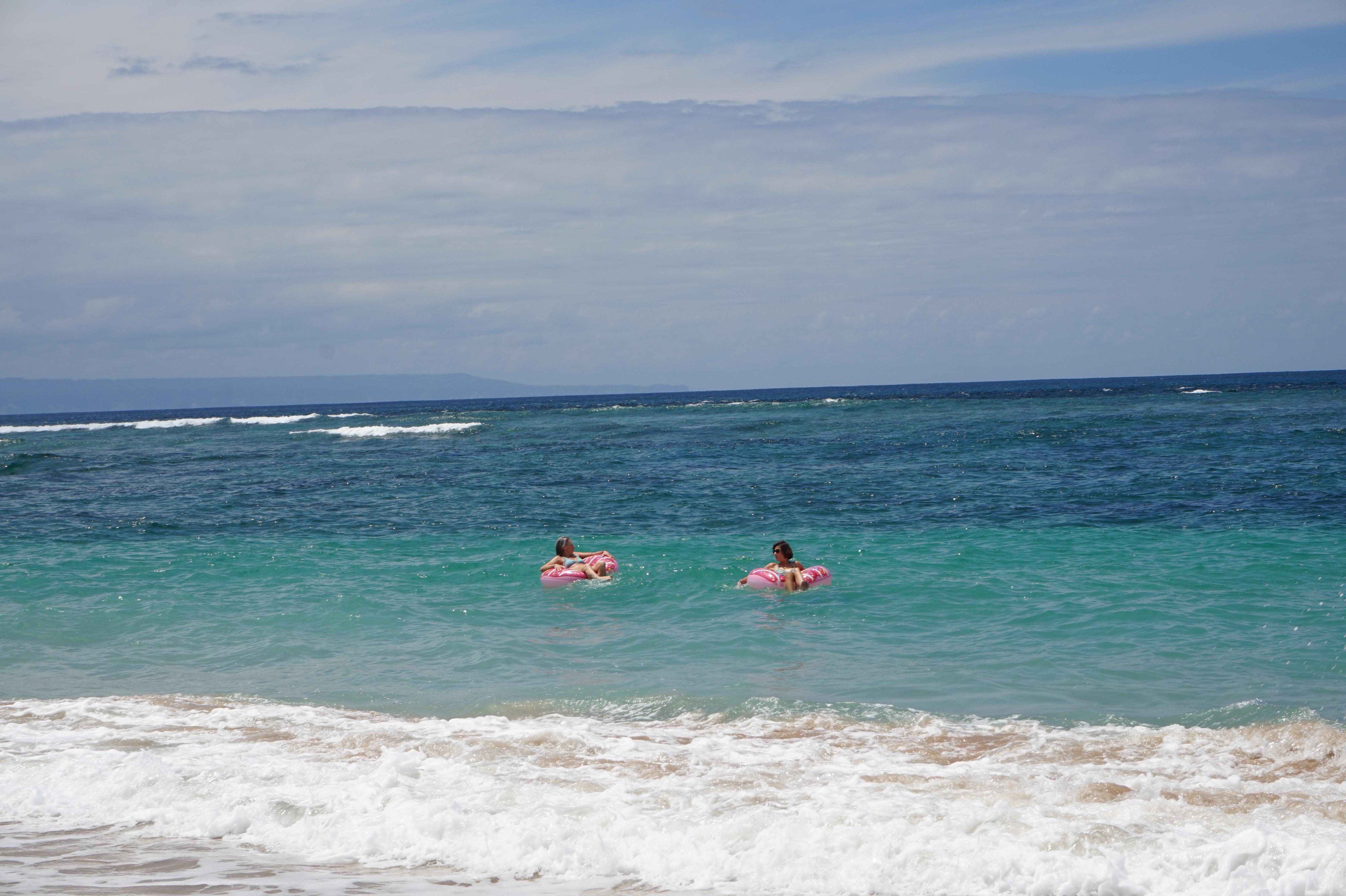 Oh hey! I'm into photography also a little bit ;) This is a picture of two old women in pink floaties in the very blue waters of the Indonesian ocean!